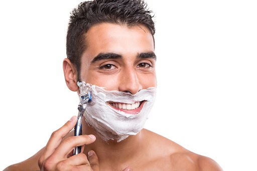 Man shaving his face 
